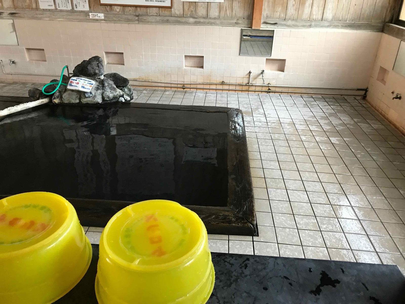 Inside a soto-yu: plain tiles, wooden walls, and water hot from the source